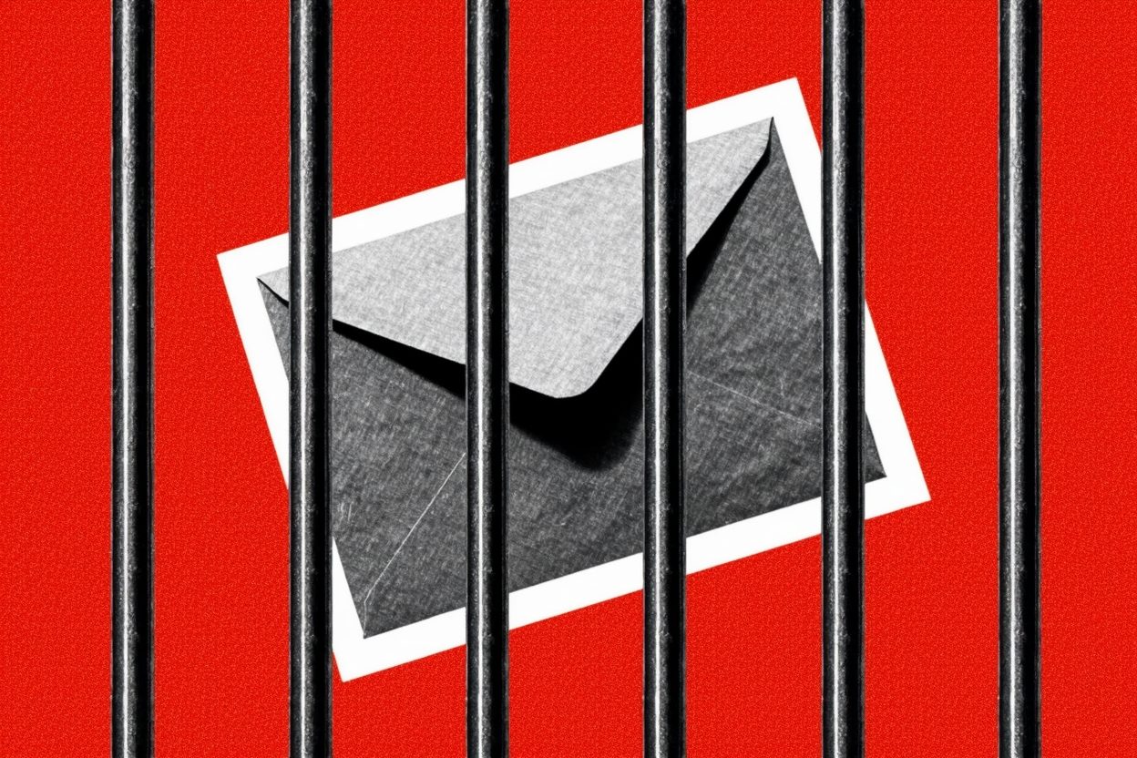 A black-and-white cutout of an envelope behind prison bars on a flat tomato-red background